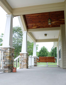 High Springs Home Designs, architect designed home, front porch with porch swing and ceiling beams